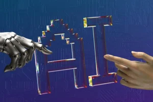 how-ai-could-create-the-first-one-person-unicorn-v0-8ondD3NHAHn2j1UVfgtDI5Ec0iEp3oGW63WkJU8VXqs.jpeg | Edsby Robot hand and human hand reaching toward a shiny 3D 'AI' glyph against a circuitry-patterned blue background, symbolizing human–AI collaboration.