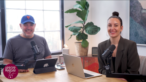 Screenshot 2026-07-16 203604 | Edsby Two podcast hosts sit at a desk with microphones and laptops, smiling at the camera in a bright studio.
